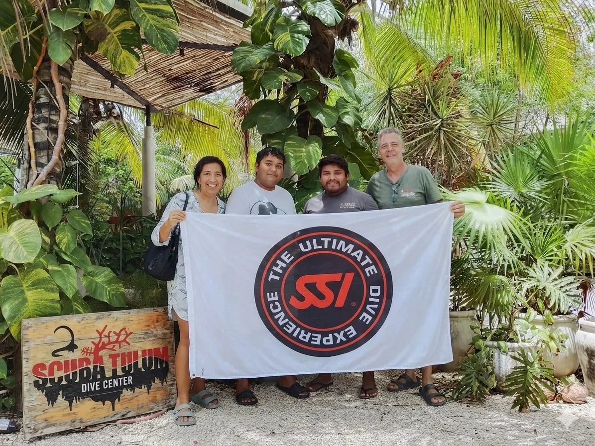 Scuba Tulum team diving in clear water