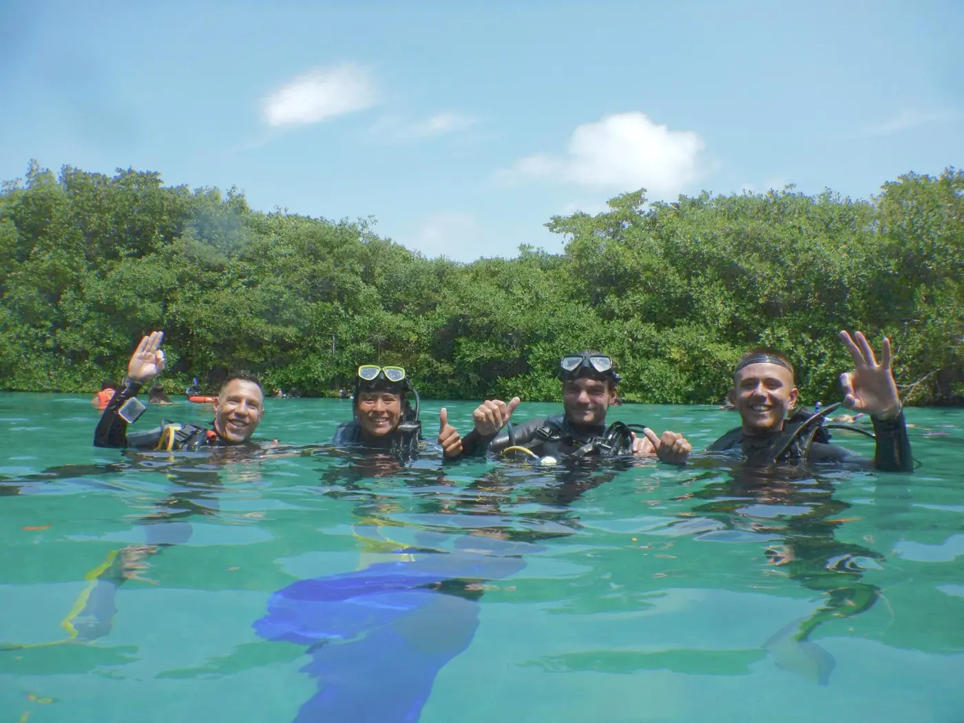 Scuba divers in clear water in Tulum