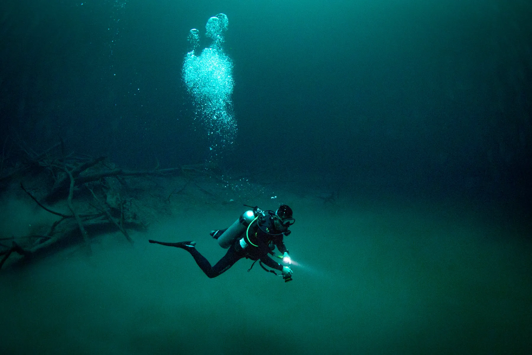 Diver hovering above the green cloud in Angelita